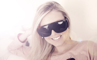 Woman pinkshirt sunglasses cellphone smile - her ear free wallpaper