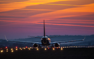 Large jetliner runway dusk city - below free wallpaper