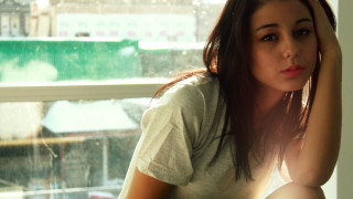 Woman window natural light cityscape - front of a window free wallpaper