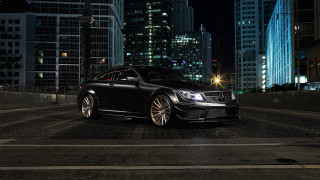 Black car city skyline night 2 - a city skyline in the background free wallpaper