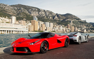 Red sports cars cityscape mountains - a city in the background free wallpaper for desktop