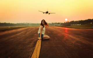 Woman kneeling plane sky beach - a plane in the background free wallpaper