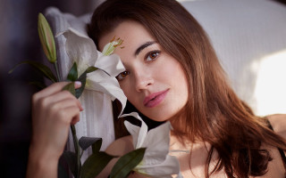 Woman holding lily smiling portrait - annabel eyres free wallpaper for desktop