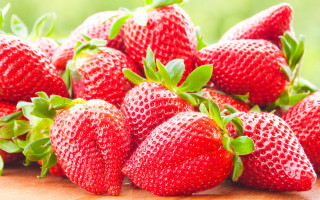 Strawberries wooden table green field - a green field of grass free wallpaper