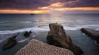 Sunset ocean rock formation island - a small island in the distance free wallpaper