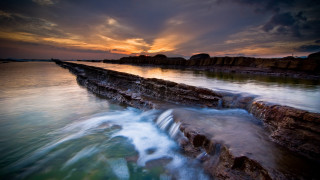 Sunset water rocks wave cityscape - the foreground and a body of water free wallpaper