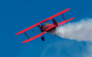 Red airplane smoke wings blue - a blue sky background free wallpaper