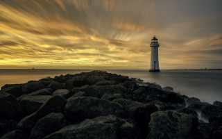 Lighthouse rocky shore cloudy sky 9 - a lighthouse free wallpaper
