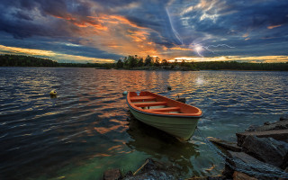 Sunset boat water rock sky - dramatic free wallpaper for desktop