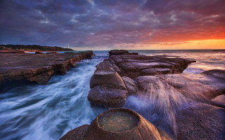 Sunset rocky beach lighthouse cloudy - a lighthouse in the distance free wallpaper