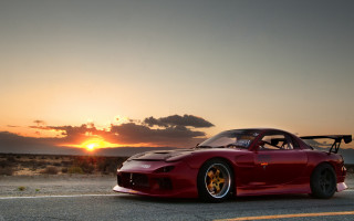 Red sports car sunset clouds 2 - the sun setting behind free wallpaper
