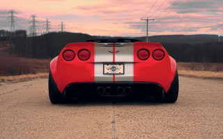 Red sports car sunset ocean - a red sky in the background free wallpaper