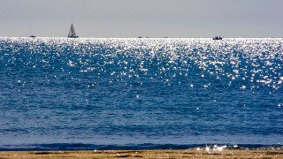 Sailboat ocean beach city sunset - the ocean water free wallpaper