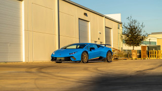 Blue sports car building tree - a garage door open free wallpaper