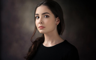 Woman black shirt serious look 2 - free portrait wallpaper for desktop