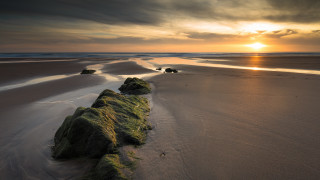 Beach rocks sunset clouds horizon - the sand and a sunset in the background free wallpaper