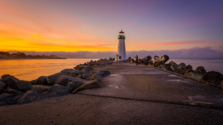 Lighthouse pier sunset clouds water - a lighthouse free wallpaper