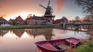 Boat shore river windmill houses - a sunset free wallpaper