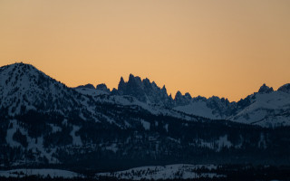 Mountain range sunset forest sky - a few snow covered mountains free wallpaper