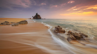Beach rock formation sunset ocean 2 - a rock formation in the middle of it free wallpaper