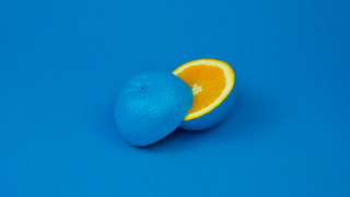 Orange half eaten blue surface - one cut free wallpaper