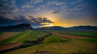 Sunset green field mountains cloudy 2 - a cloudy sky above free wallpaper