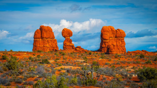 Desert rock formation trees bushes 2 - a large rock formation in the middle of a desert area free wallpaper