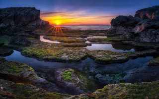 Sunset rocky beach reflection mountain - a sunset over a rocky beach free wallpaper