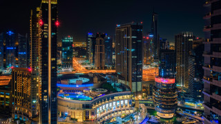 City night lights urban scene - the background and a street light in the foreground free wallpaper