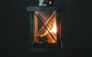 Small stove lit candle dark - a black table free wallpaper