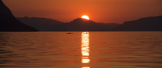 Boat sunset mountains person water - a boat free wallpaper