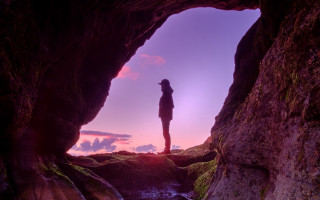 Cave person ocean sunset purple - liminal space free wallpaper for desktop