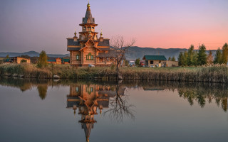 Wooden church reflection sunset mountains - a tower free wallpaper