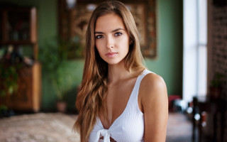 Woman white top green walls - a picture in a room free wallpaper