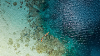 Boat beach rocks ocean night - a blue ocean free wallpaper for desktop