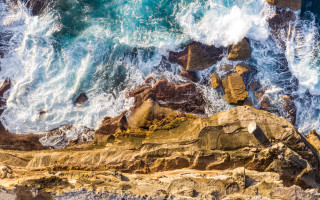 Bird rock ocean waves splashing - aerial free wallpaper