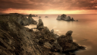 Rocky cliff water cloudy sky 5 - a rocky cliff free wallpaper