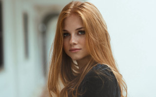 Woman redhair serious portrait blurry - her face and shoulder free wallpaper