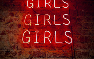 Neon sign girls brick wall - feminist free wallpaper