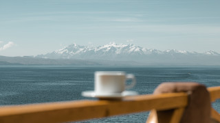 Coffee railing mountains water boat - a body of water and mountains free wallpaper