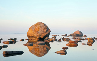 Large rock lake surrounding rocks - auseklis ozol free wallpaper