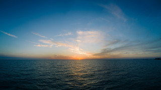 Sunset ocean boat clouds horizon 4 - a boat in the distance free wallpaper