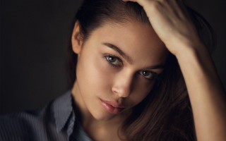 Woman blue shirt black background - free portrait wallpaper for desktop