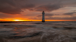 Lighthouse ocean sunset cloudy sky - radiant light free wallpaper