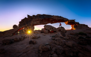 Person rock formation sunset arch - wide angle len free wallpaper