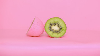 Kiwi fruit sliced pink background - food photography free wallpaper