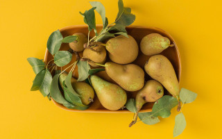 Pear bowl leaves yellow background - food photography free wallpaper