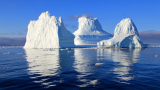 Iceberg ocean birds sky mountains - a large iceberg free wallpaper
