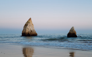 Ocean rocks swimming beach mountains - two large rock free wallpaper
