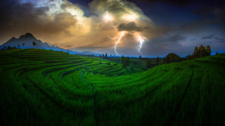 Stormy mountain landscape green field - a mountain in the background free wallpaper